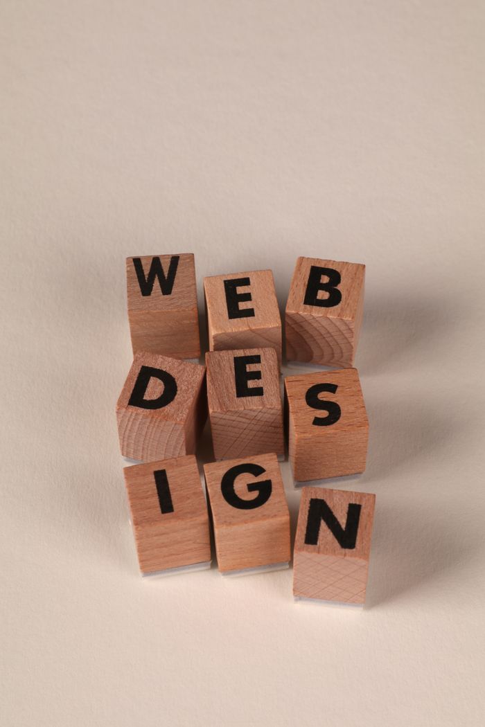 about-us-01 Wooden blocks arranged to spell Web Design. Perfect for creative, digital content themes.